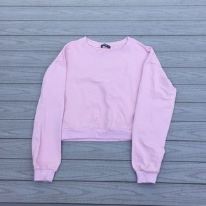 Light pink cropped shirt.